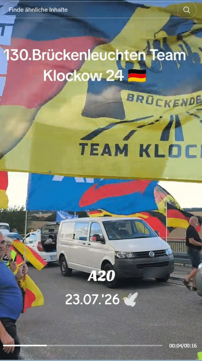 Standbild vom 23. Juli 2026: große Vereinsfahne der Gruppe an einem hohen Mast auf der Brücke